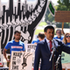 Rep. Ro Khanna speaks at an “End Fossil Fuel” rally near the U.S. Capitol on June 29, 2021 in Washington, DC, with protestors holding signs in the background with slogans such as "Keep It in the Ground" and "Off Fossil Fuels."